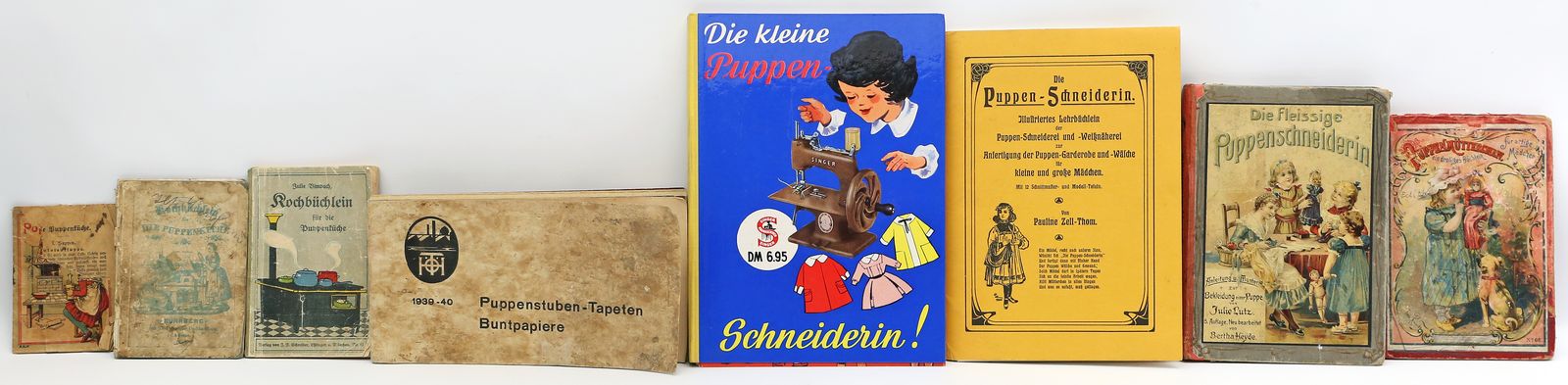 7 Bücher und Heft mit Buntpapieren für die Puppenstuben-Tapeten.